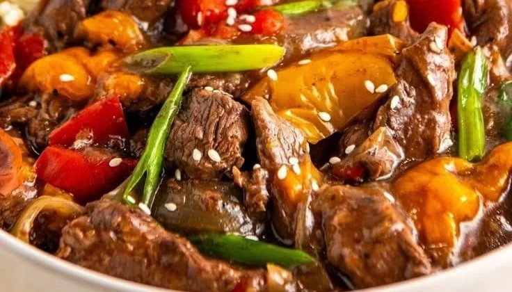 A bowl of delicious Crockpot Pepper Steak with colorful bell peppers and tender beef.
