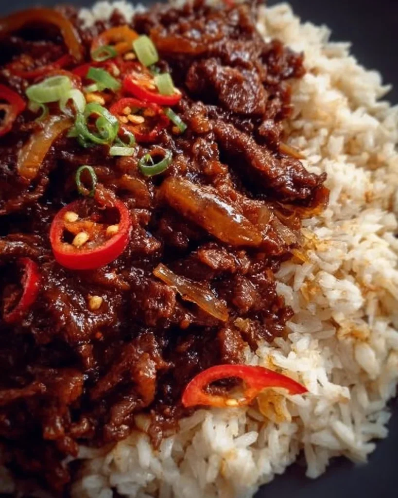 Plate of delicious chilli beef served with rice garnish