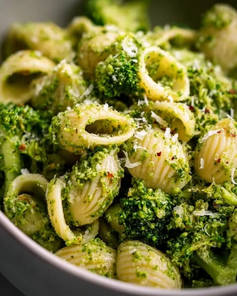 Bowl of easy healthy broccoli pasta topped with grated cheese and herbs
