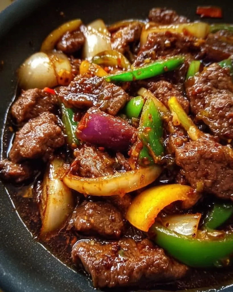 Sizzling Chinese pepper steak with onions served on a plate