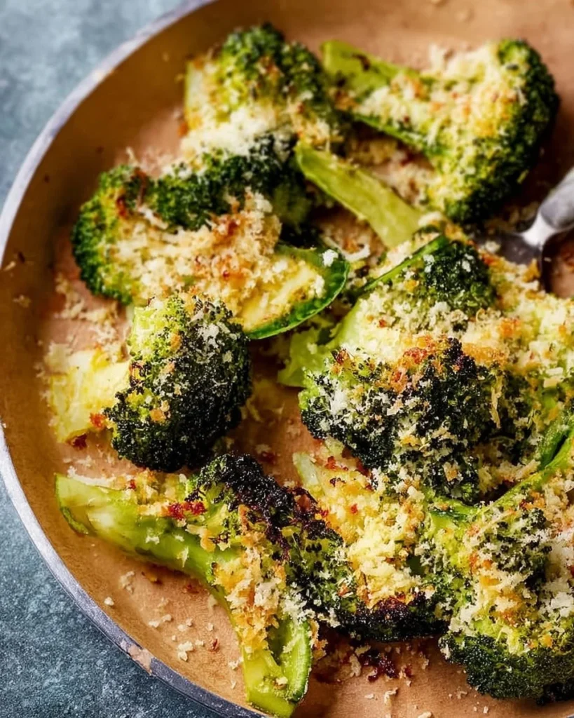 Smashed Parmesan Broccoli served on a plate with garnishes