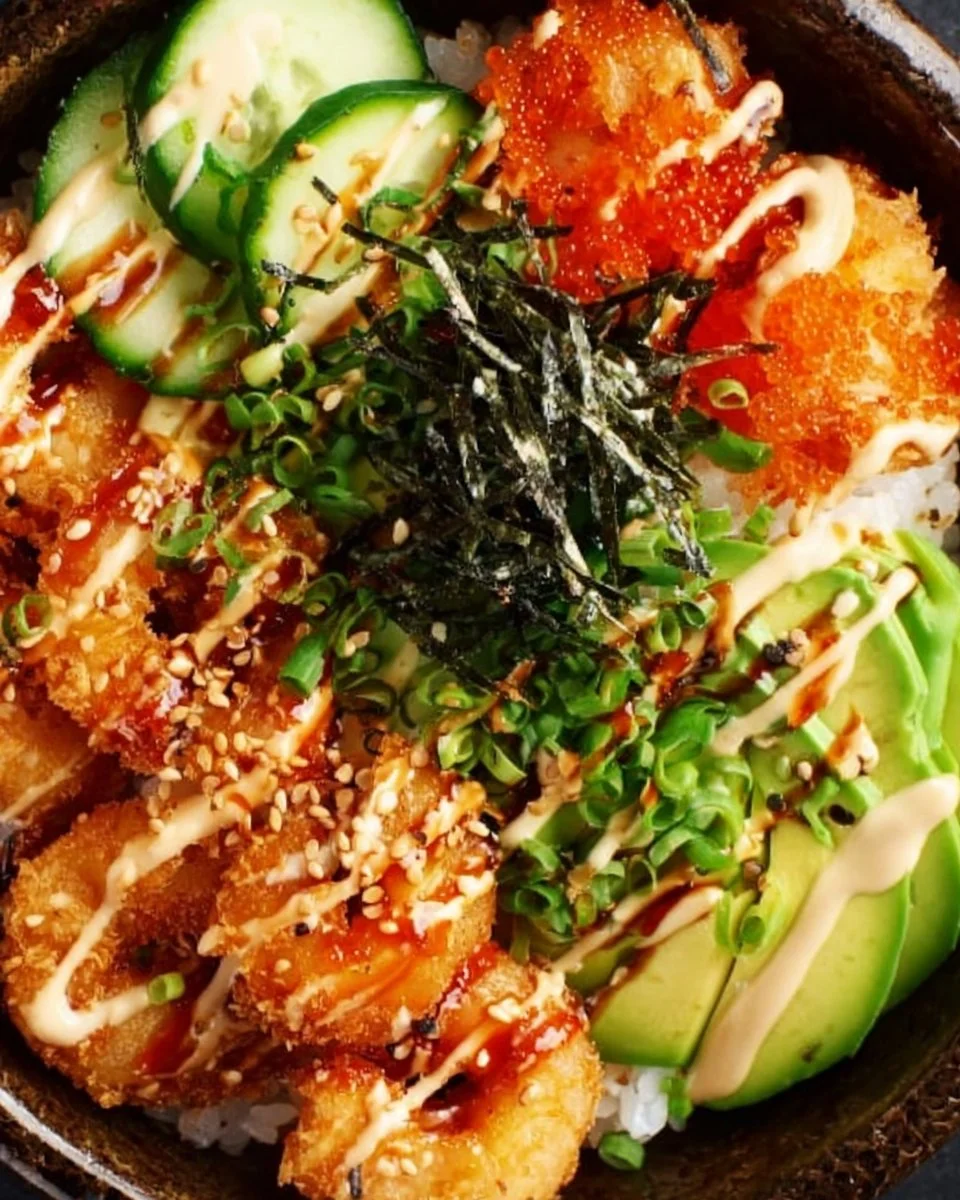 Delicious crispy shrimp sushi bowl with fresh vegetables and sauces