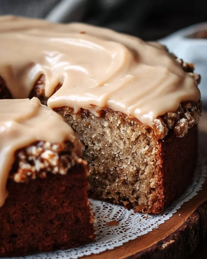 Homemade zucchini cake with brown sugar icing on a wooden platter