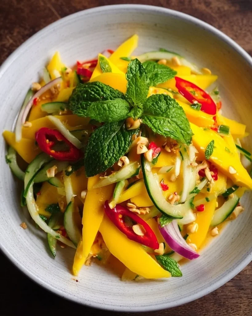 Sweet and spicy Thai mango salad with fresh mango, herbs, and dressing