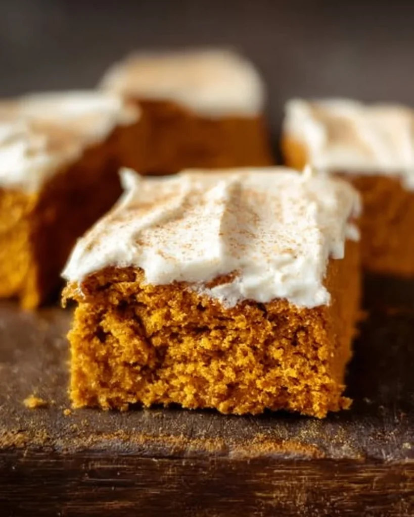Delicious homemade pumpkin bars with cream cheese frosting on a plate