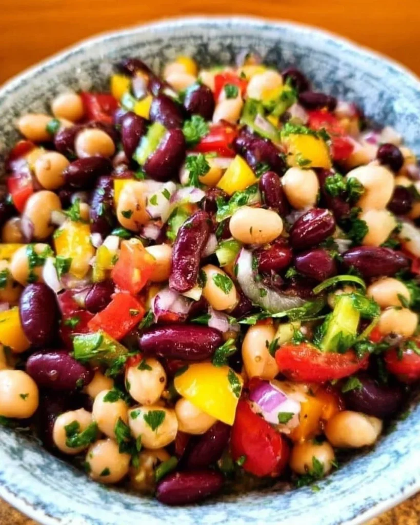 Colorful and healthy bean salad served in a bowl with fresh vegetables.