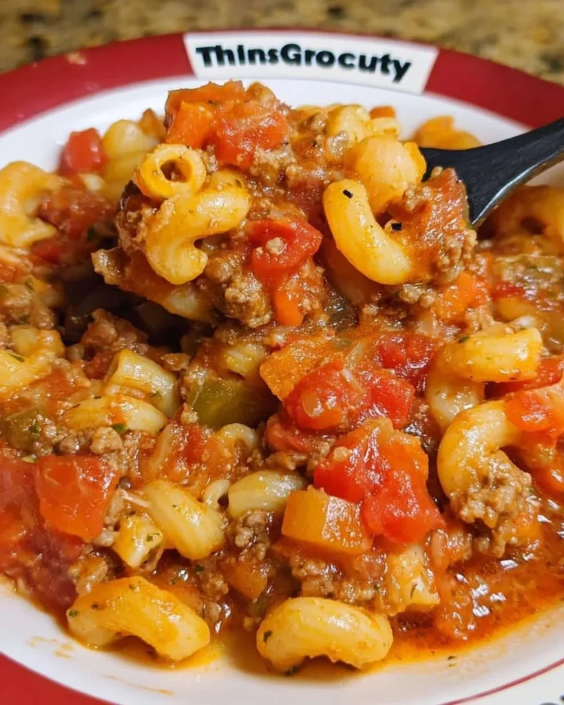 Delicious Crock Pot American Goulash in a bowl topped with cheese and herbs
