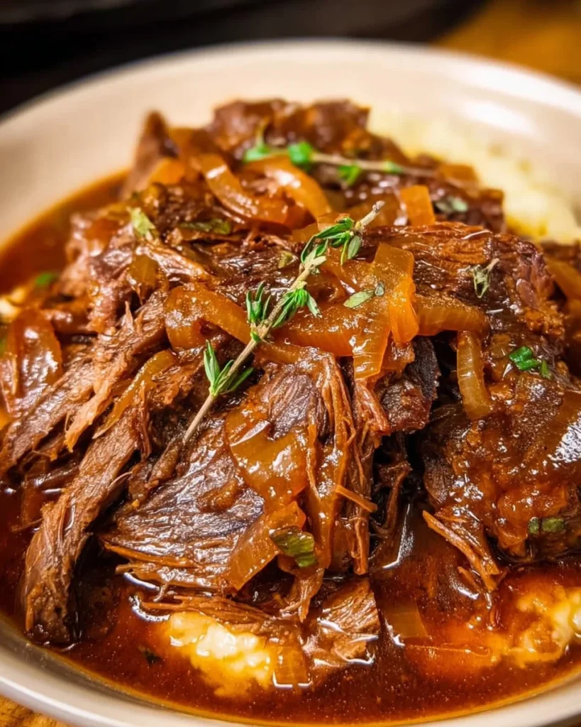 Delicious Crock Pot French Onion Pot Roast ready to serve on a plate.