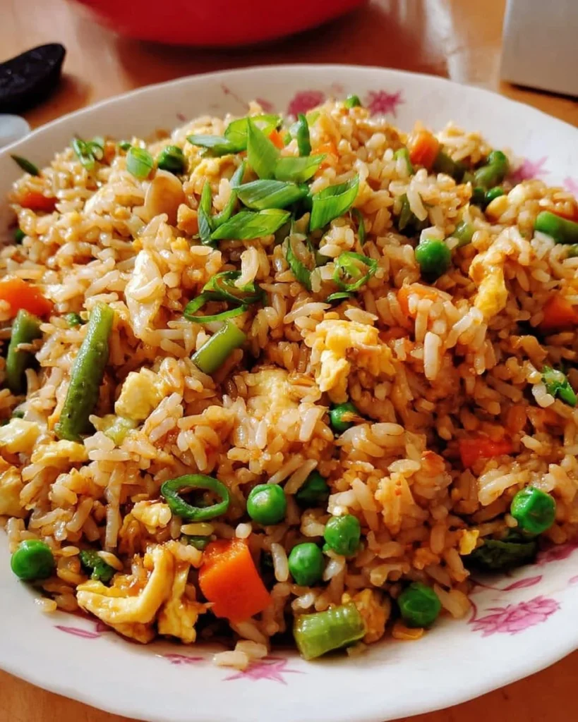 A flavorful plate of fried rice with vegetables and protein
