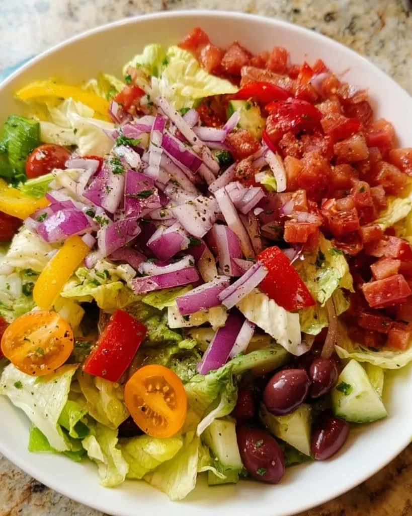 A colorful Italian Chopped Salad with fresh vegetables and Italian dressing.
