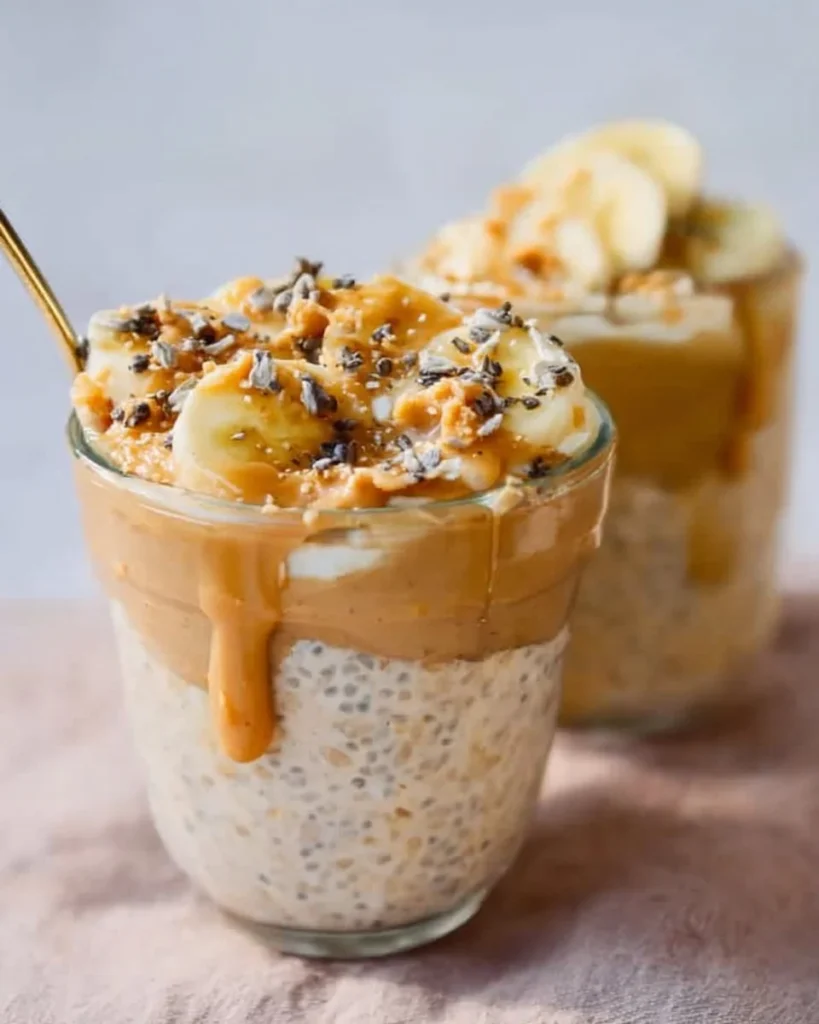 Delicious peanut butter banana overnight oats in a glass jar with toppings