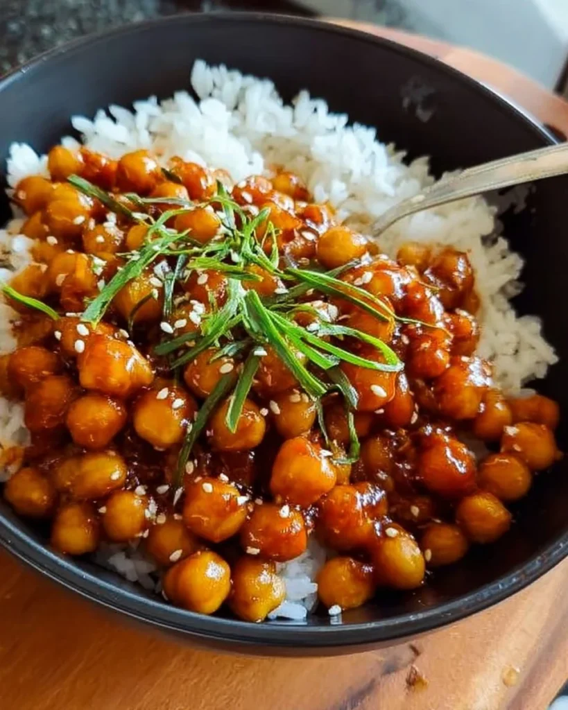 Plate of Sweet and Sour Chickpeas garnished with herbs.