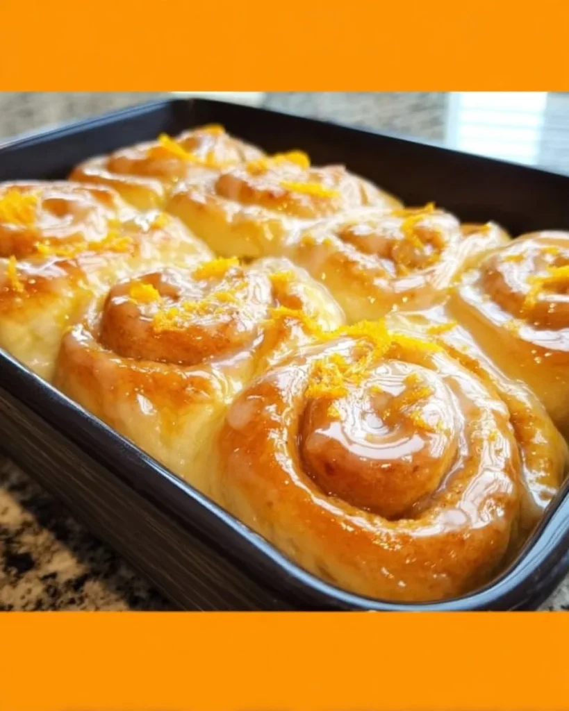 Freshly baked glazed orange sweet rolls with citrus glaze