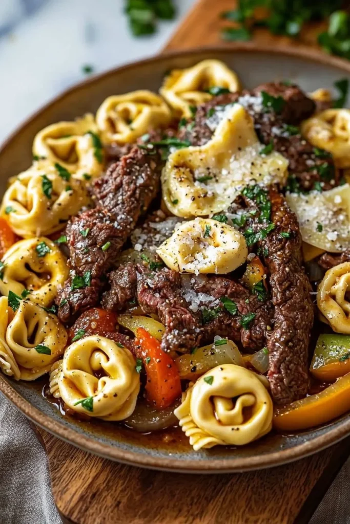 Beef cheesesteak tortellini served with fresh herbs and cheese