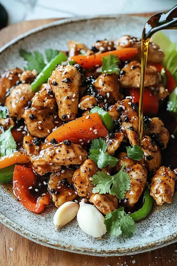 Delicious Black Pepper Chicken served with vegetables on a plate