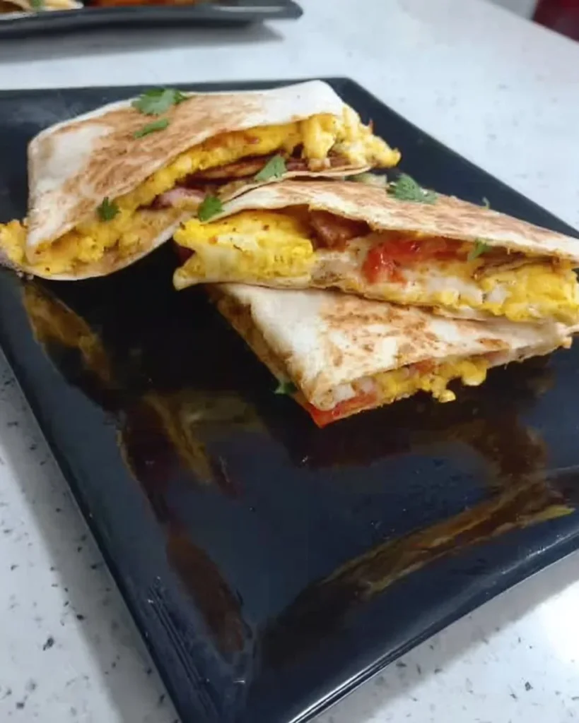 Delicious breakfast quesadilla with eggs, cheese, and vegetables in a tortilla