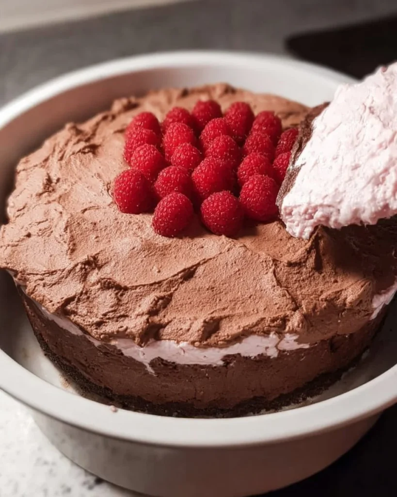 Decadent Chocolate Raspberry Mousse Cake with fresh raspberries on top