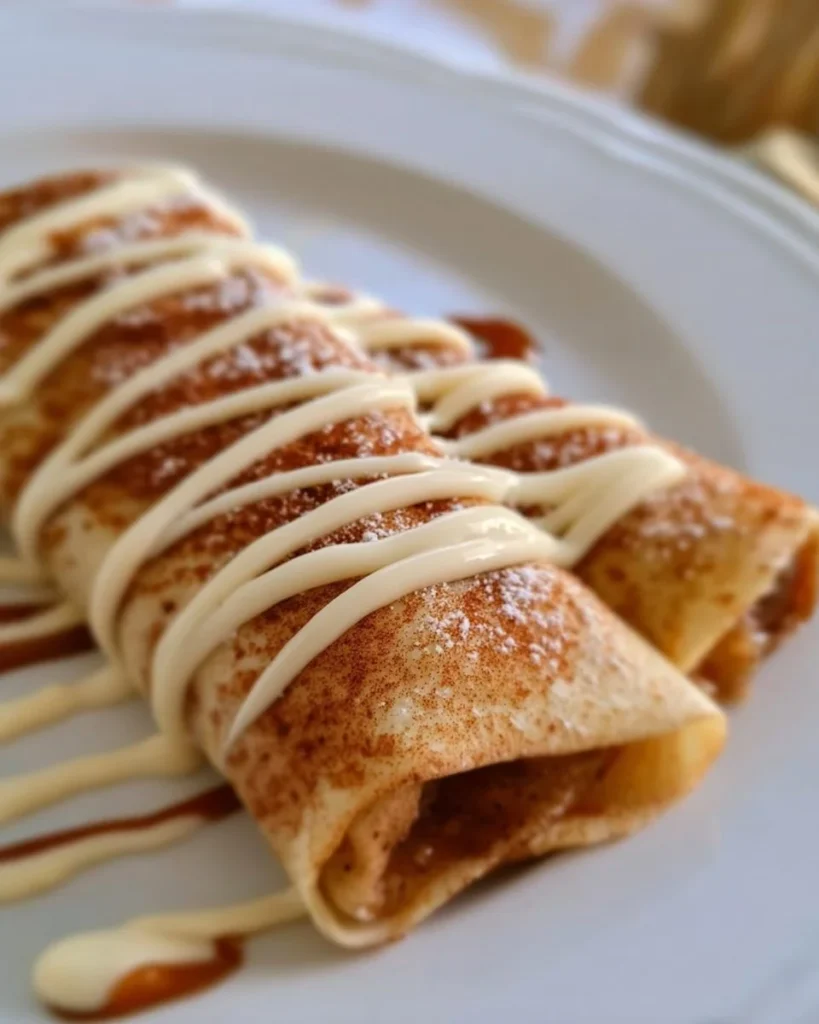 Delicious Cinnamon Roll Protein Crepes topped with cinnamon and protein-rich ingredients.