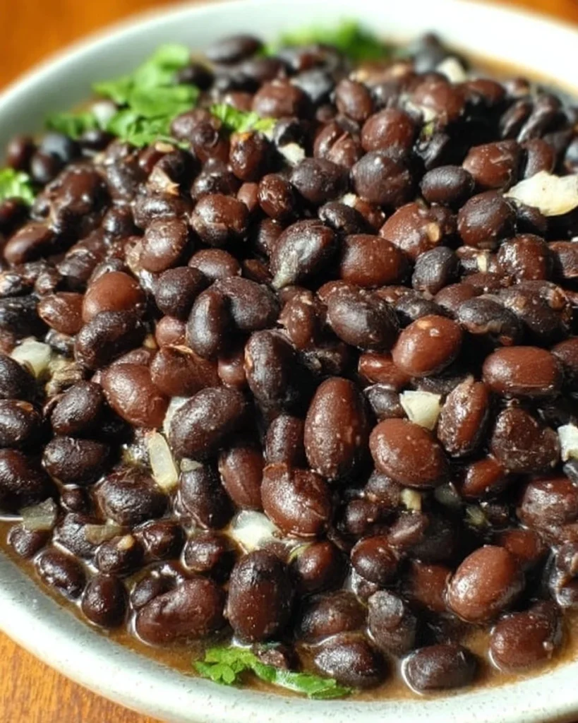 Delicious Mexican black beans served in a traditional dish with spices.