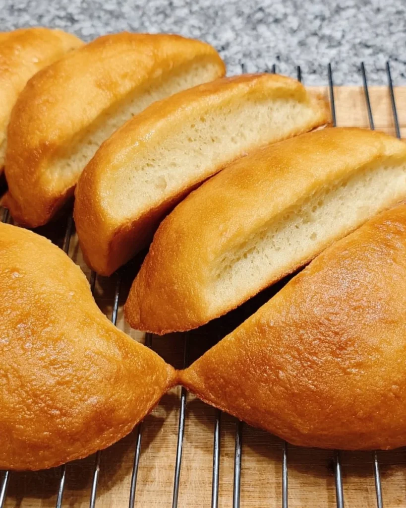 Freshly baked Vegan Jamaican Coco Bread on a wooden table