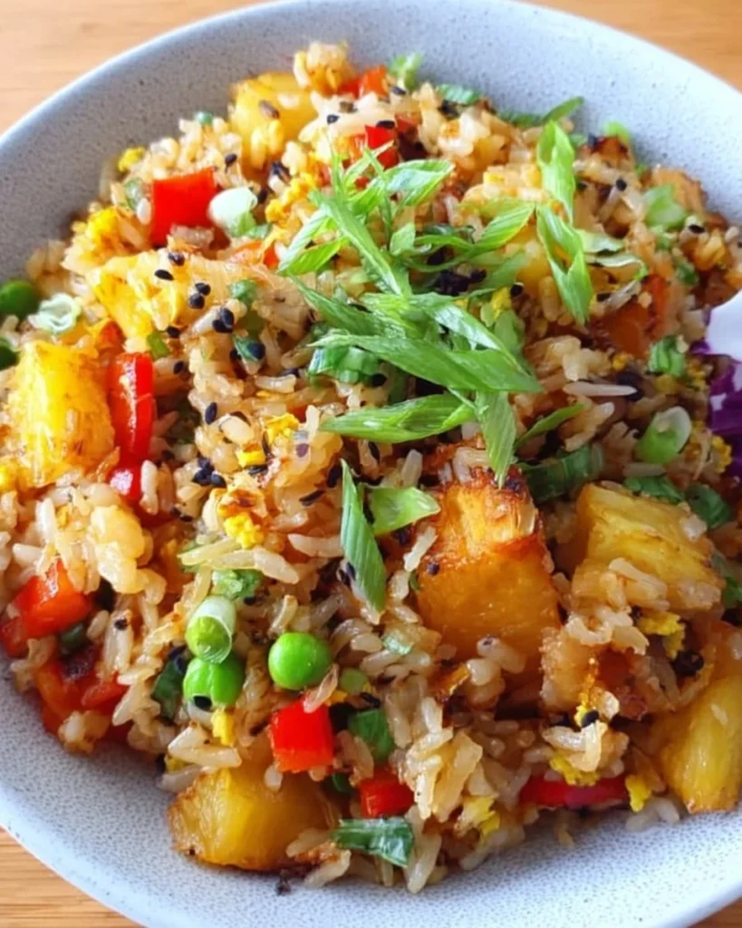 Vegan Pineapple Fried Rice dish with colorful vegetables and pineapple chunks