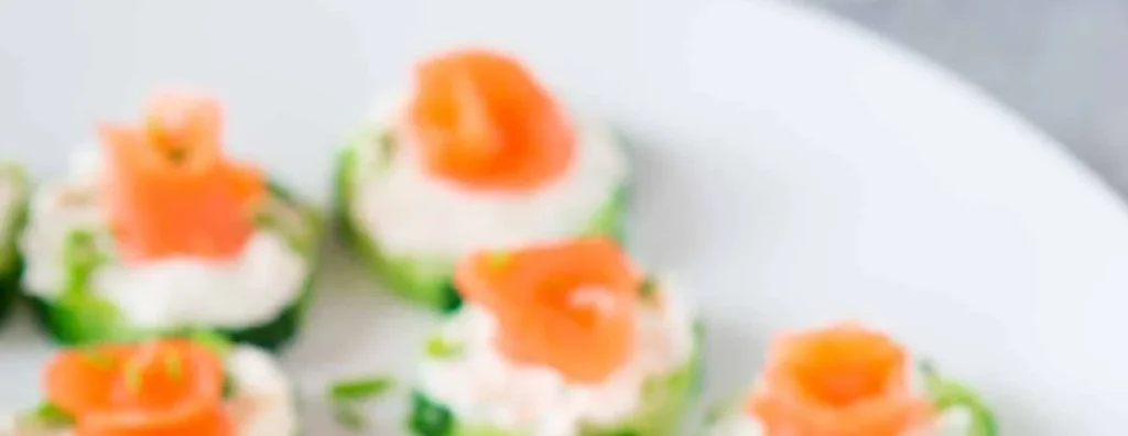 Delicious smoked salmon cucumber bites served on a platter.