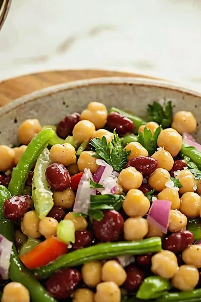 Three bean salad with colorful vegetables and a light dressing