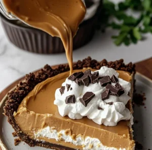 Decadent peanut butter pie topped with chocolate and whipped cream