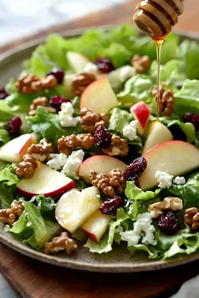 A vibrant Easy Honeycrisp Salad showcasing fresh apples, greens, and nuts in a bowl.
