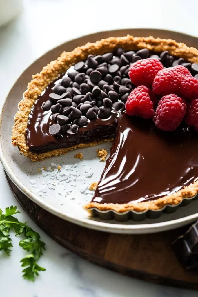 Delicious no bake dark chocolate tart topped with chocolate shavings