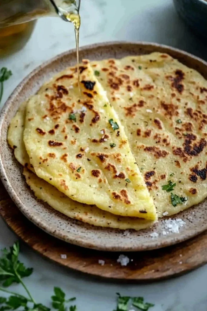 Homemade Potato Flatbread on a wooden table with herbs