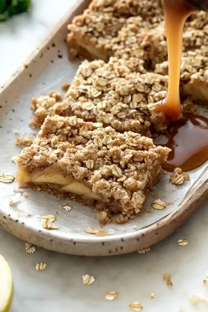 Delicious Salted Caramel Apple Crisp Bars topped with crunchy oat crumble