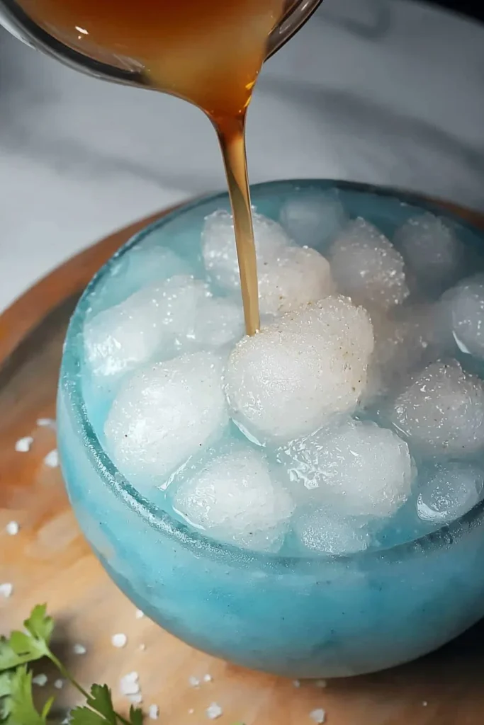 Colorful frozen slushy drink in a clear cup with a straw