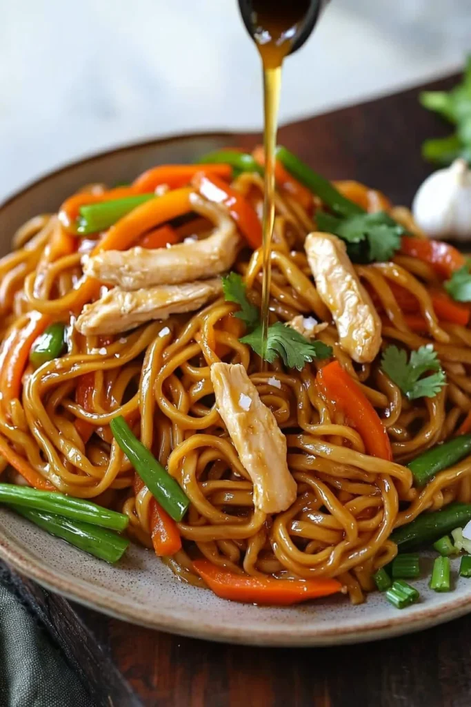Delicious Chicken Lo Mein with vegetables and noodles in a savory sauce.
