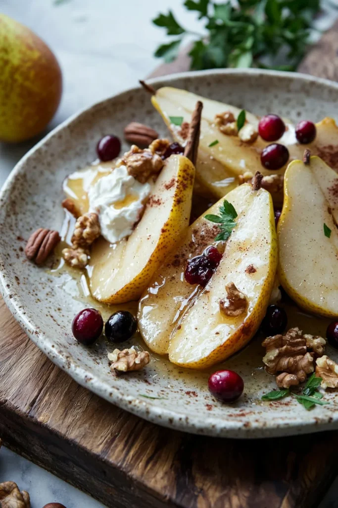 Baked pears with cream cheese, honey, and cranberries served on a plate