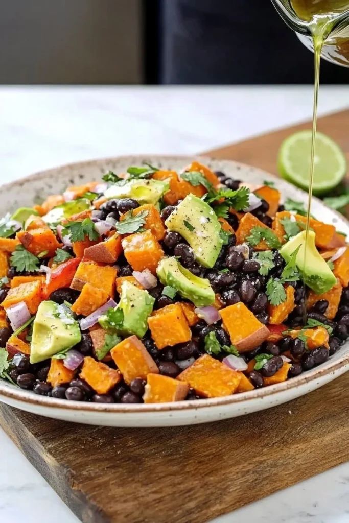 Colorful black bean salad with roasted sweet potatoes and fresh vegetables