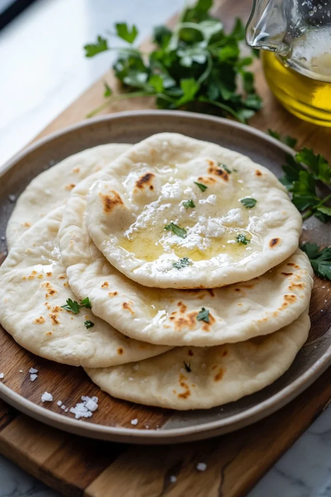 Freshly baked homemade pita bread on a wooden table