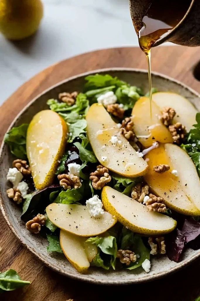 Fresh pear salad with greens, nuts, and cheese