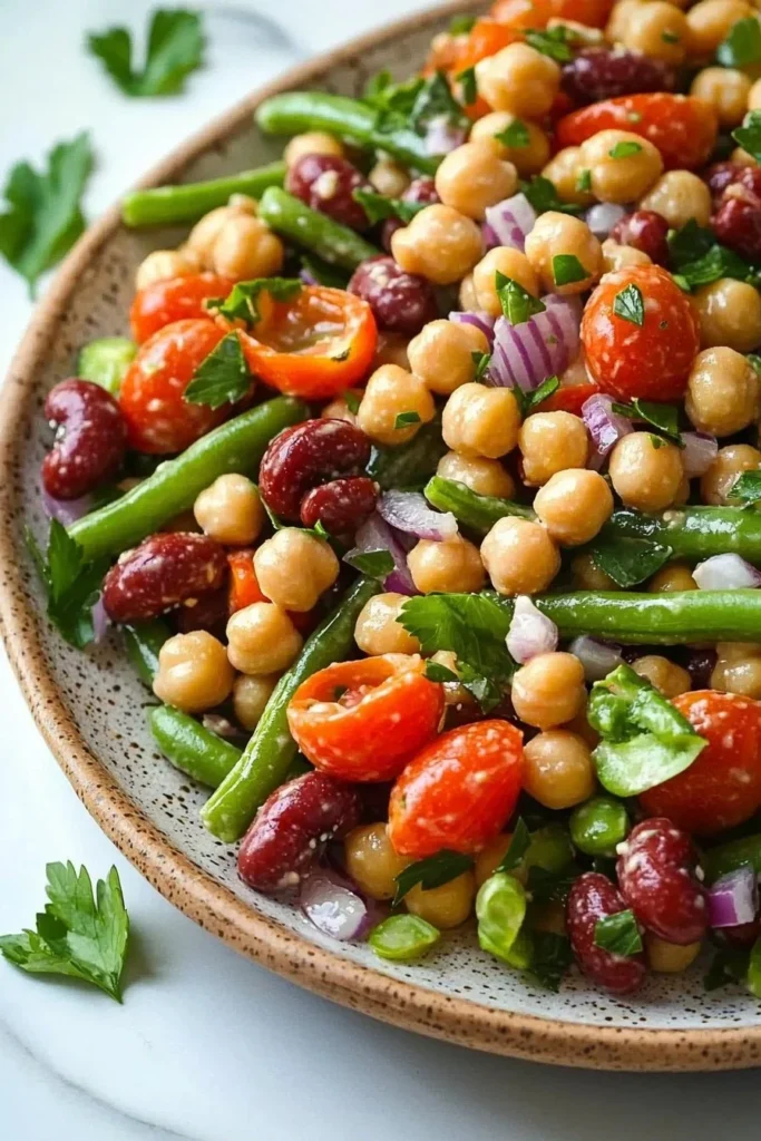 Colorful three bean salad with mixed beans, vegetables, and dressing